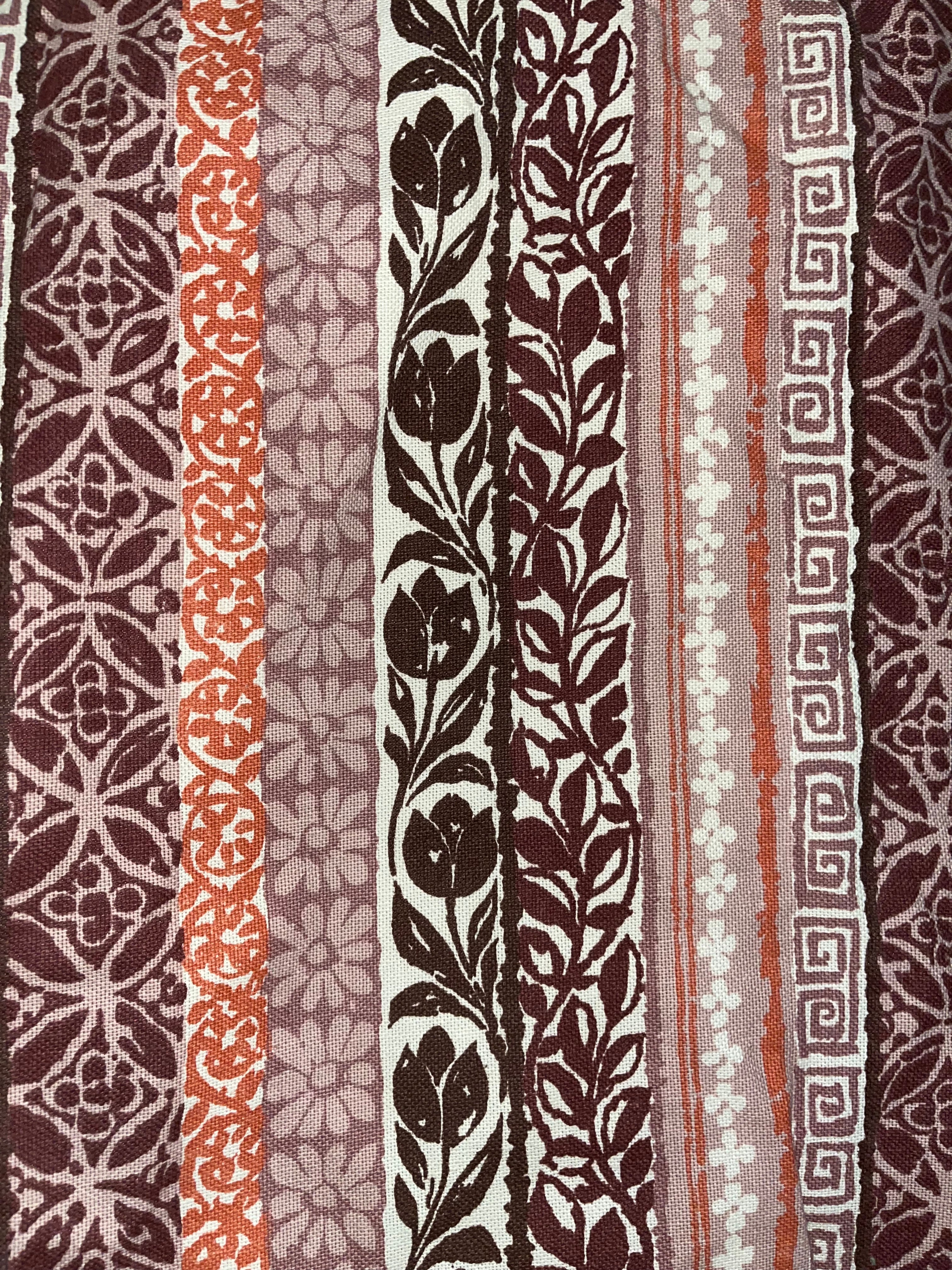 Collection of various patterned fabric strips in brown, white, and red.