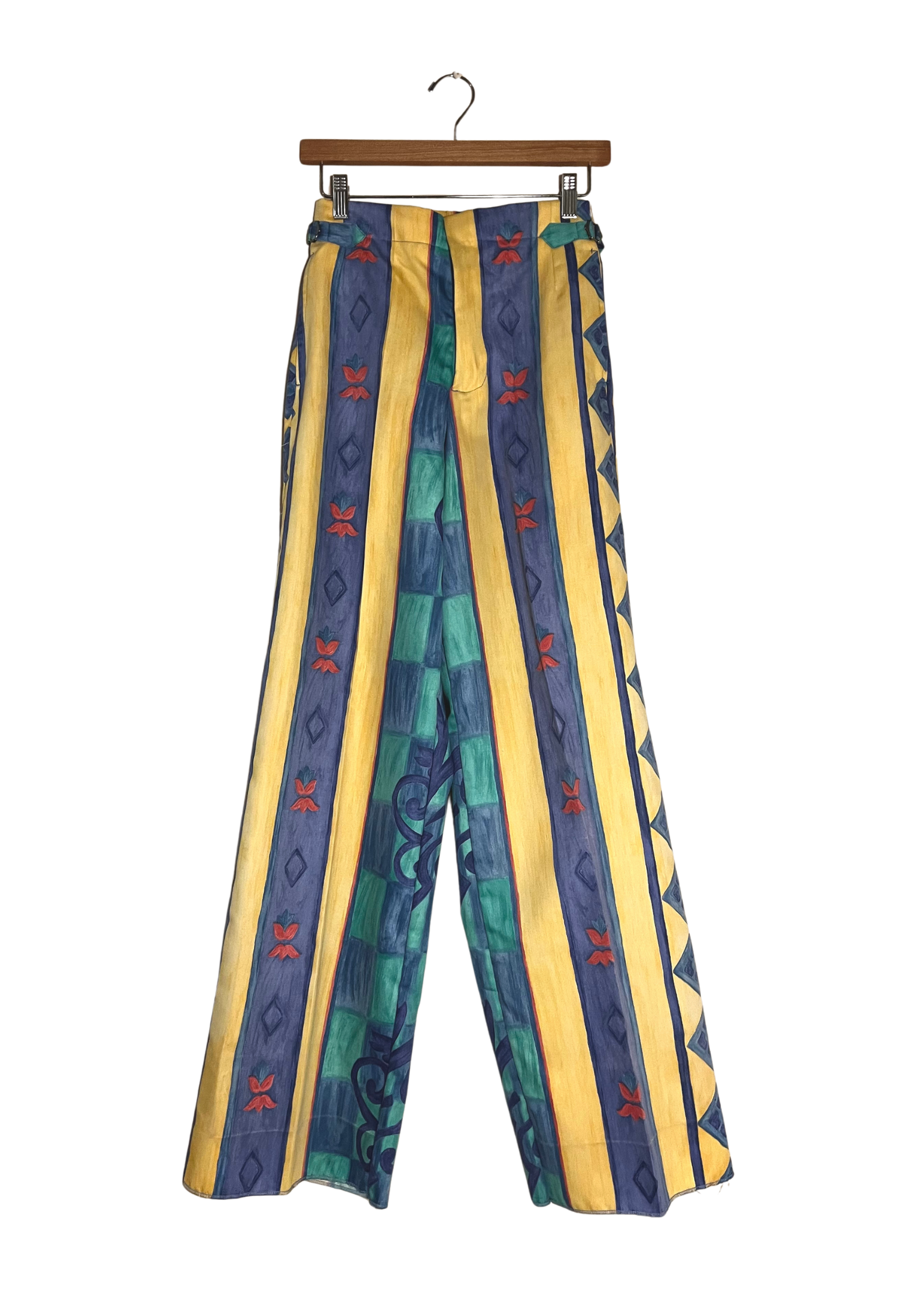Colorful striped pants on a hanger against a white background