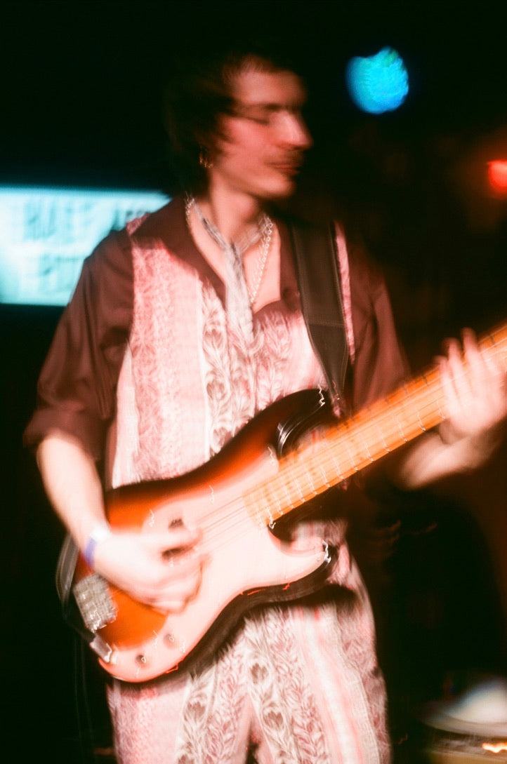 Person playing a guitar with a blurred background