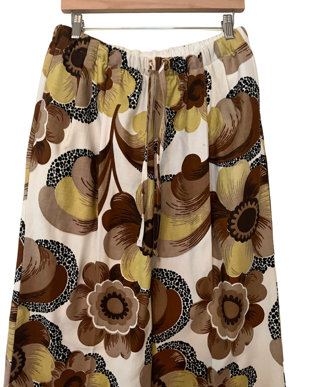 Floral patterned skirt on a hanger with a white background