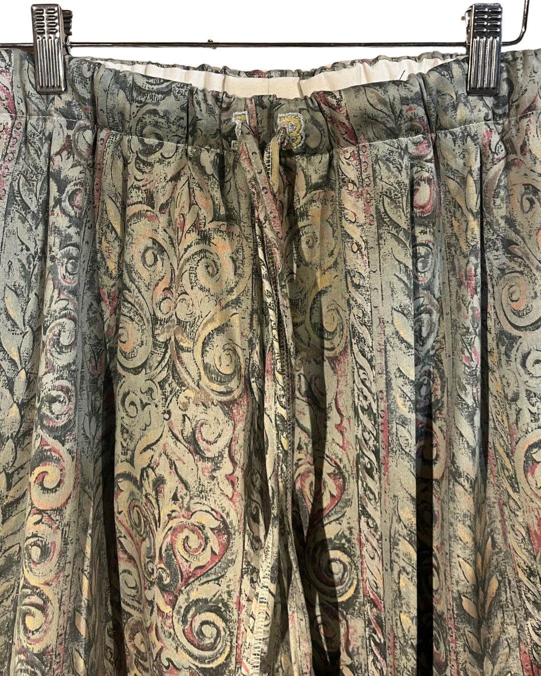 Patterned curtains with decorative clips on a white background