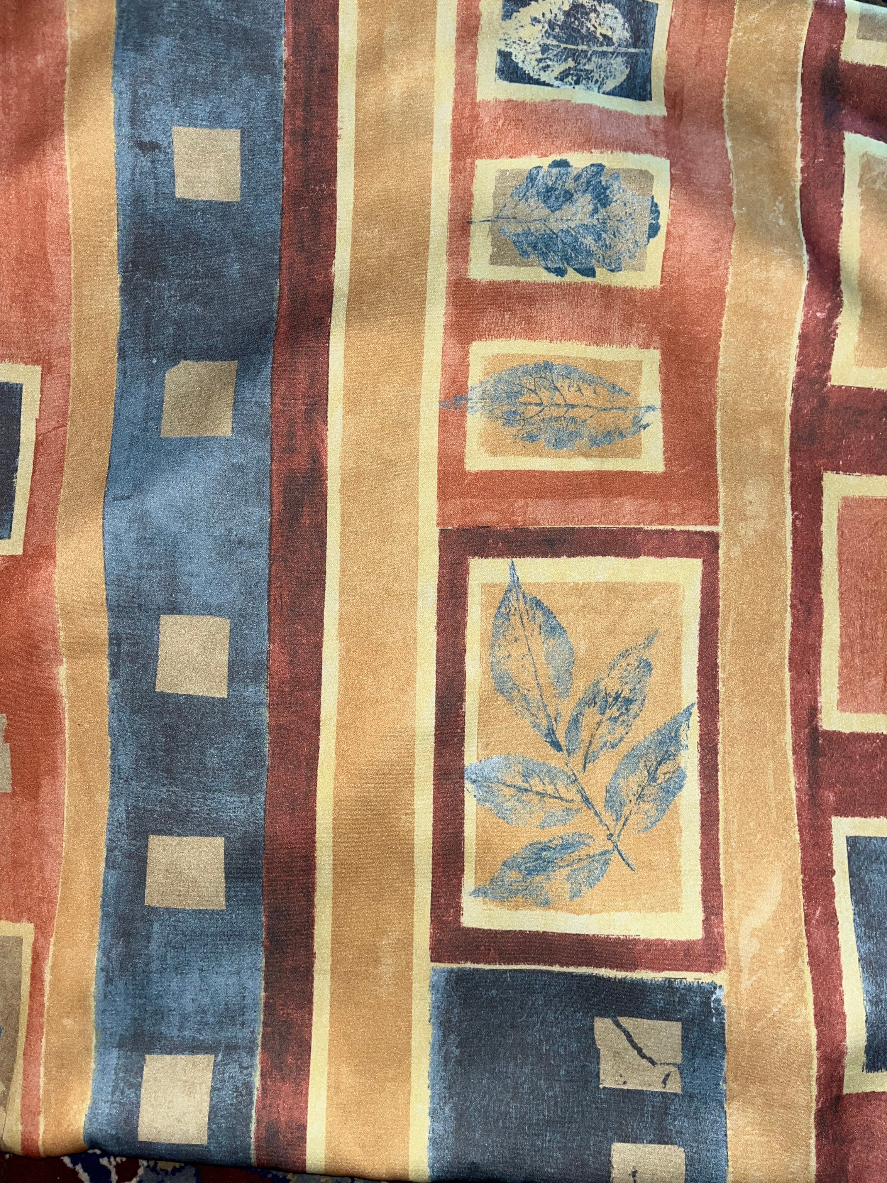 Textile with leaf patterns and color blocks