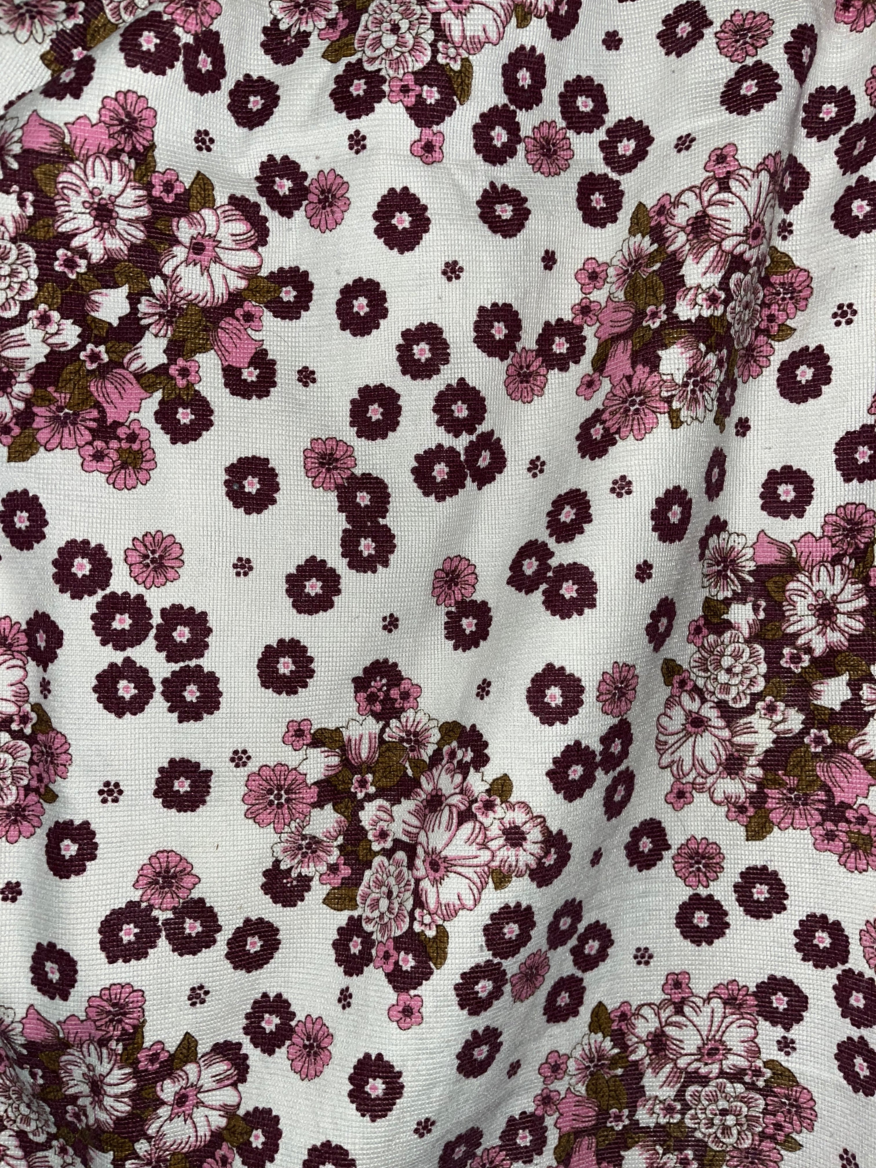 Floral patterned fabric with pink and purple flowers on a white background