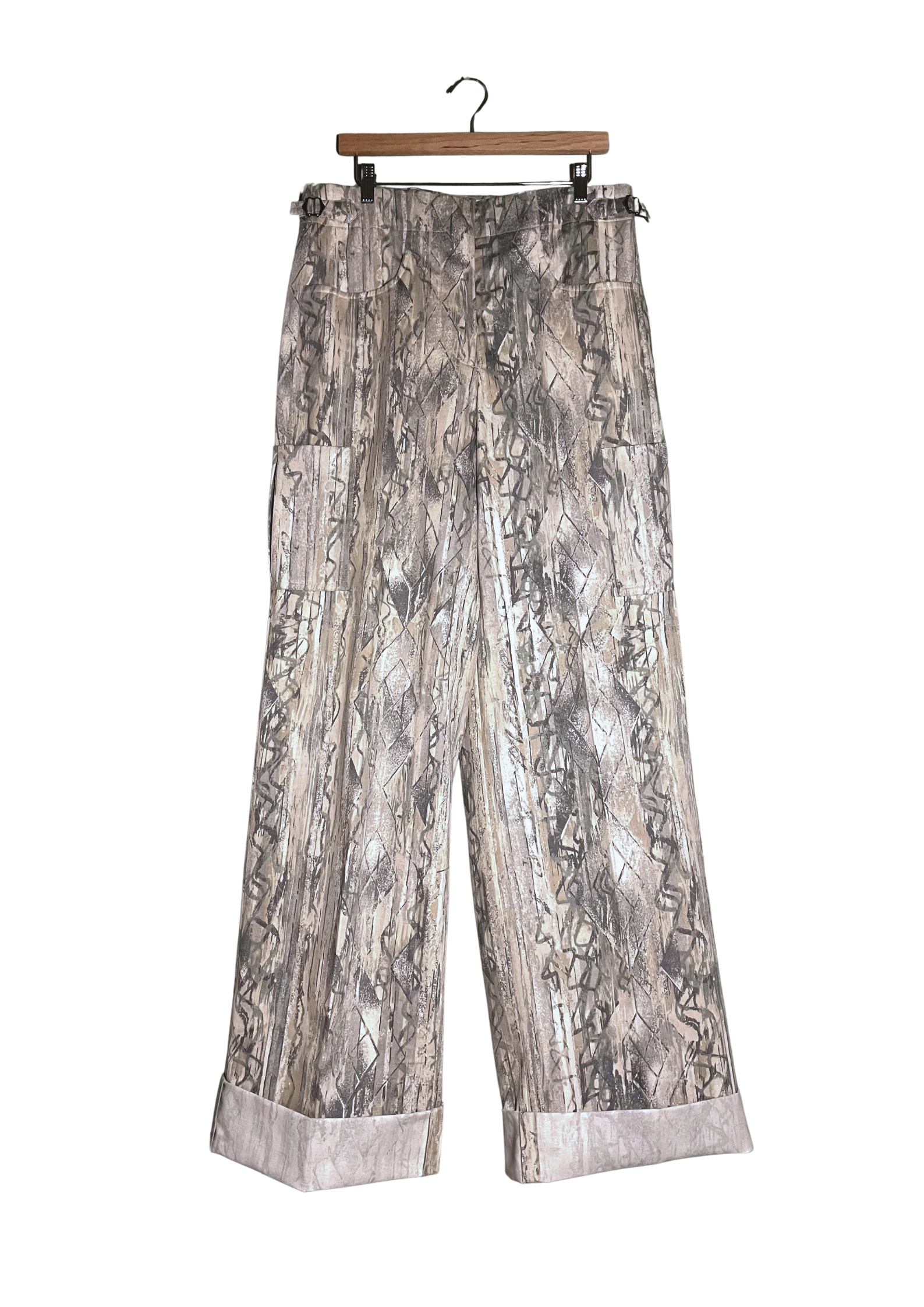 Patterned pants on a hanger against a white background