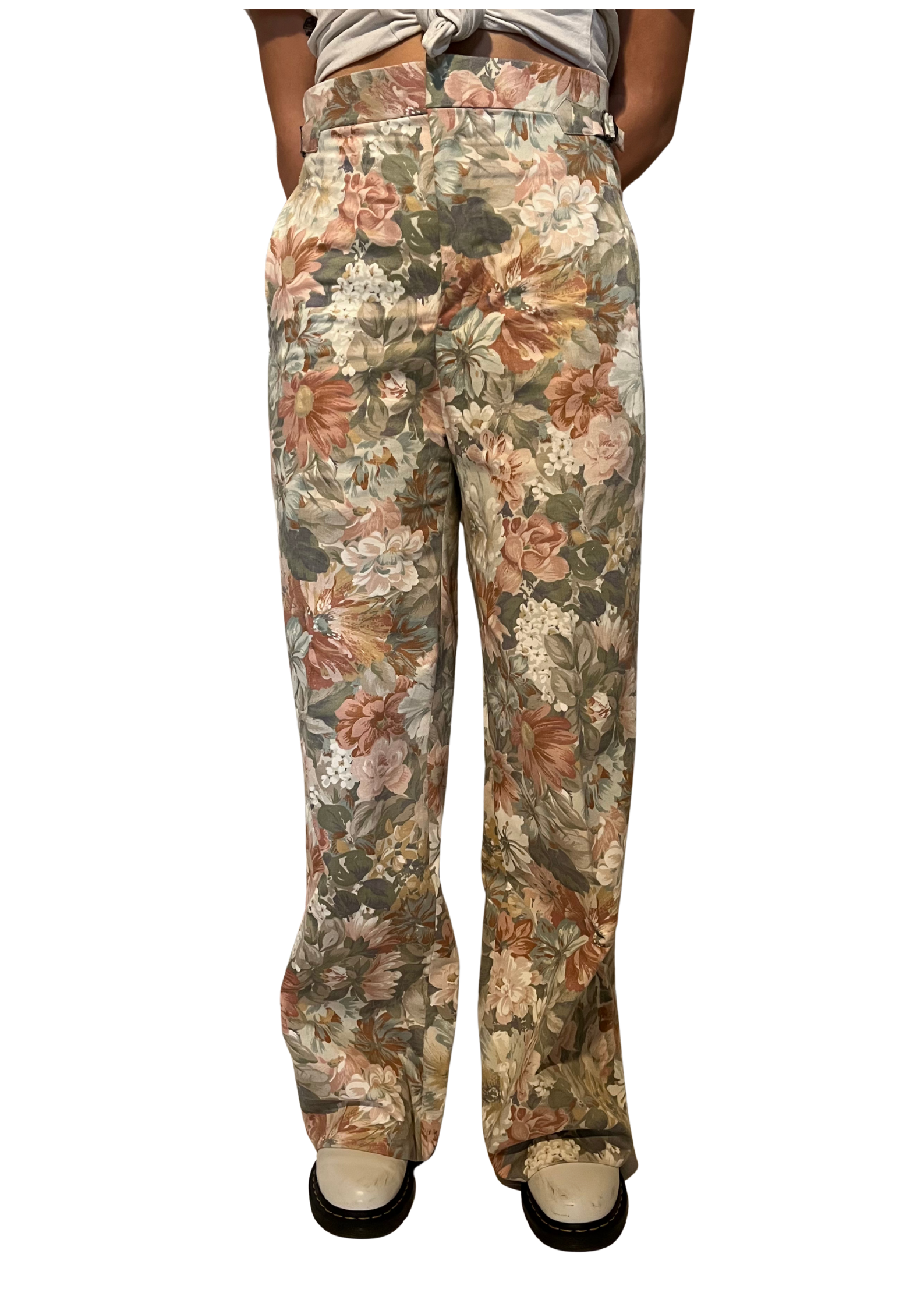 Floral patterned pants worn by a person on a white background