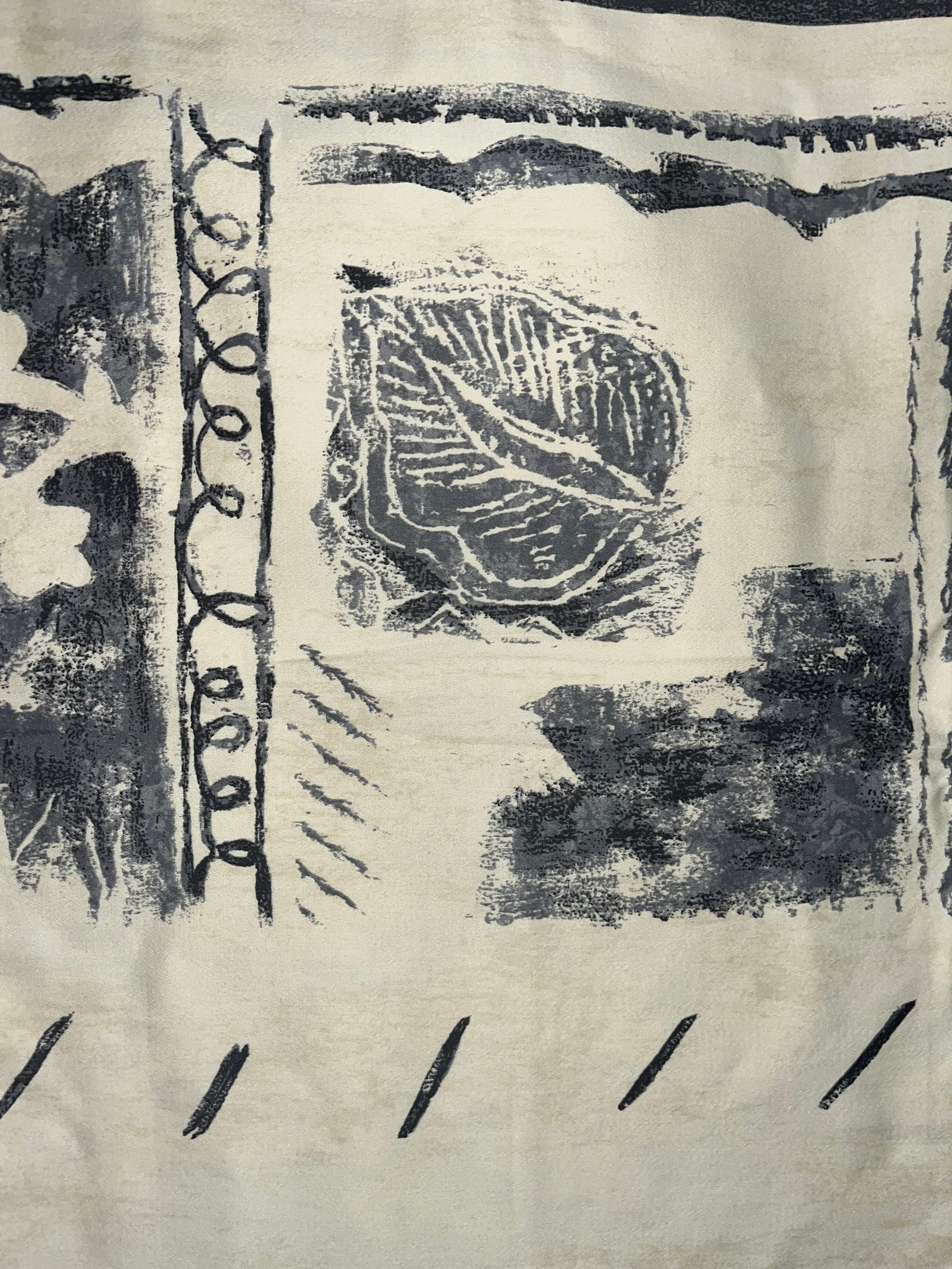Textile with leaf pattern and text on a plain background