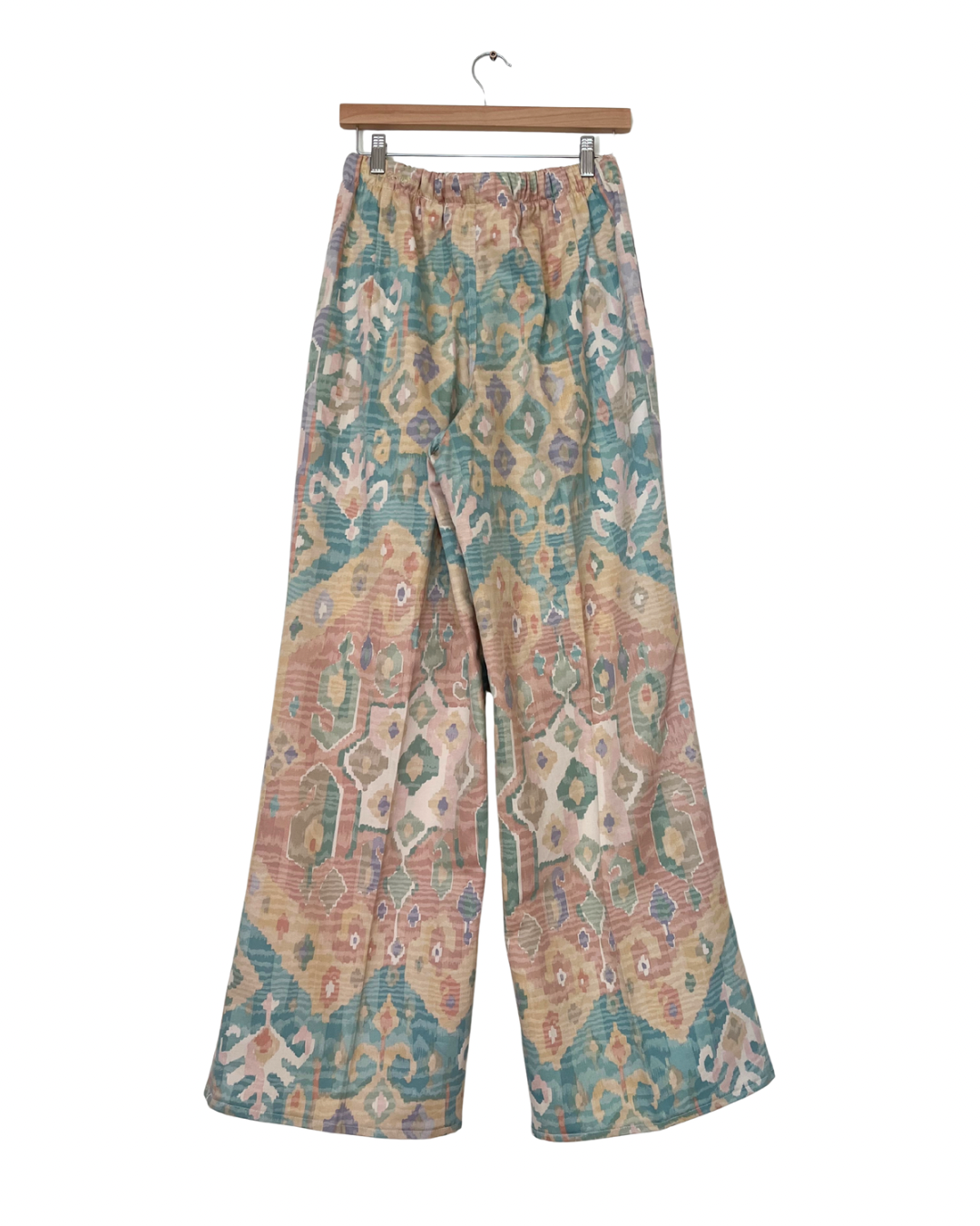 Handmade upcycled wide-leg trousers from vintage curtain fabric with pastel geometric ikat pattern in peach, teal, and cream – sustainable fashion by JB’s.