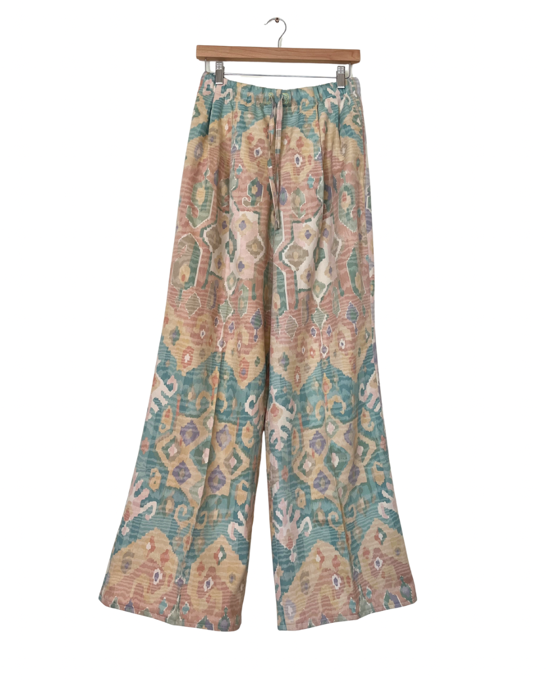 Handmade upcycled wide-leg trousers from vintage curtain fabric with pastel geometric ikat pattern in peach, teal, and cream – sustainable fashion by JB’s.